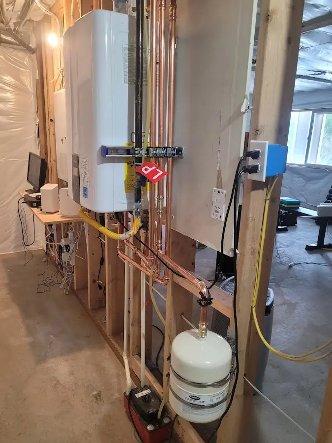 Licensed plumber repairing a kitchen sink in St. Clair